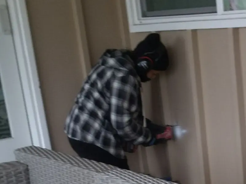 Professional electrician installing an exterior outlet in Irwin